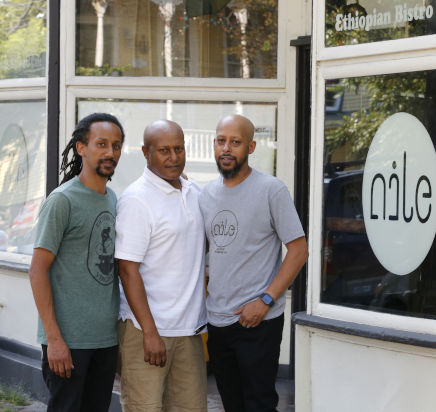 Nathan Teklemariam with his twin brothers, Yoseph and Benyam