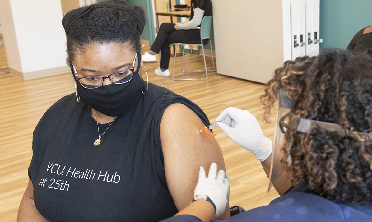 Resident getting Covid-19 vaccine shot at VCU Health Hub.